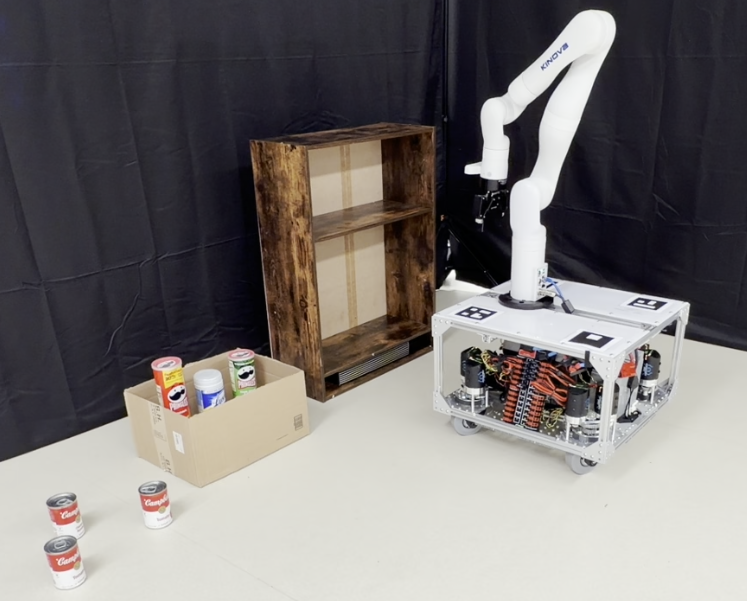 Initial scene of a Restock3D problem: the TidyBot mobile manipulator next to an empty two-level shelf, with cans in a box and on the floor.